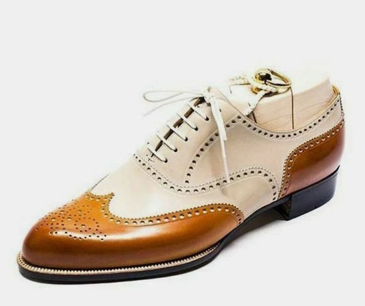 Two-tone leather shoe with tan and beige colors on a white background