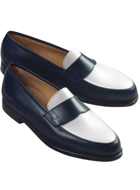 Pair of navy and white loafers on a white background
