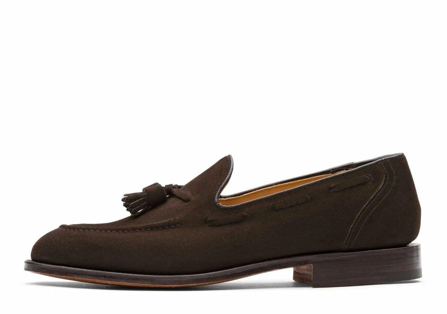 Brown suede loafer with a tassel on a white background
