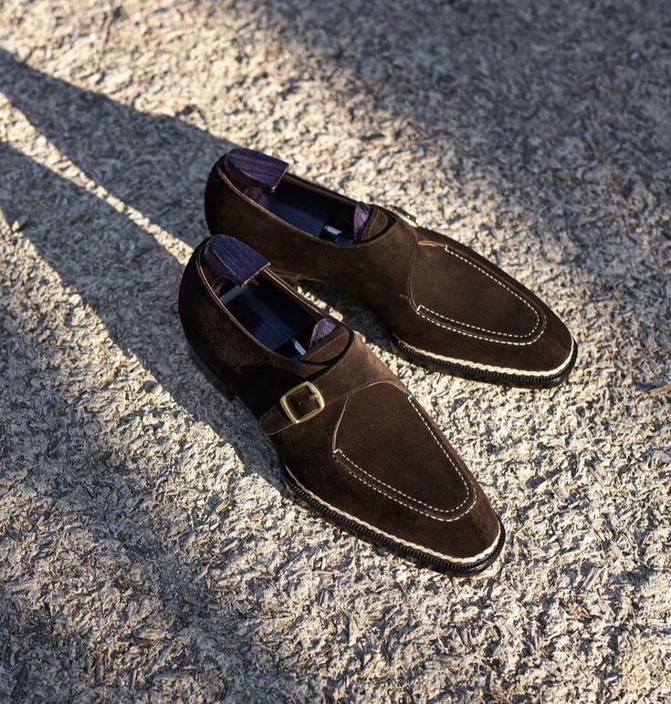 Pair of brown loafers on a textured concrete surface