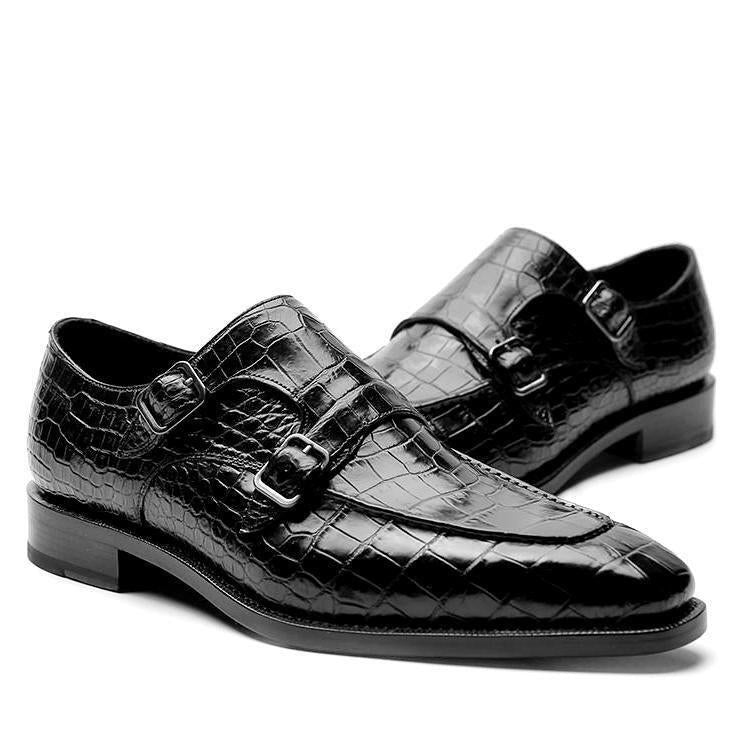 Black crocodile-patterned dress shoes with buckles on a white background