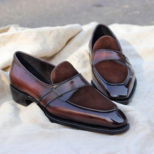 Pair of brown loafers on a textured fabric surface