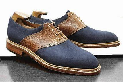 Pair of blue and brown leather shoes on a reflective surface